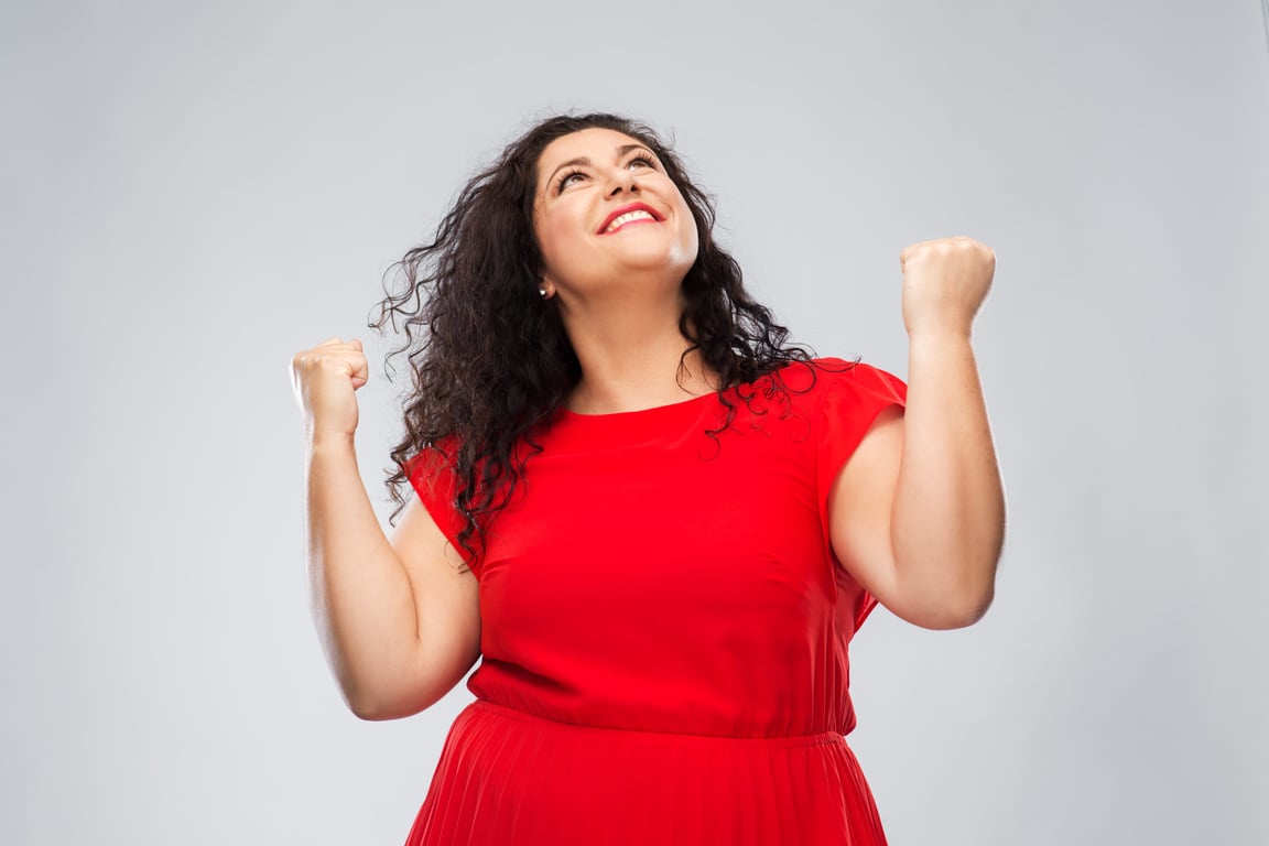 Happy Woman in Red Dress Celebrating Success